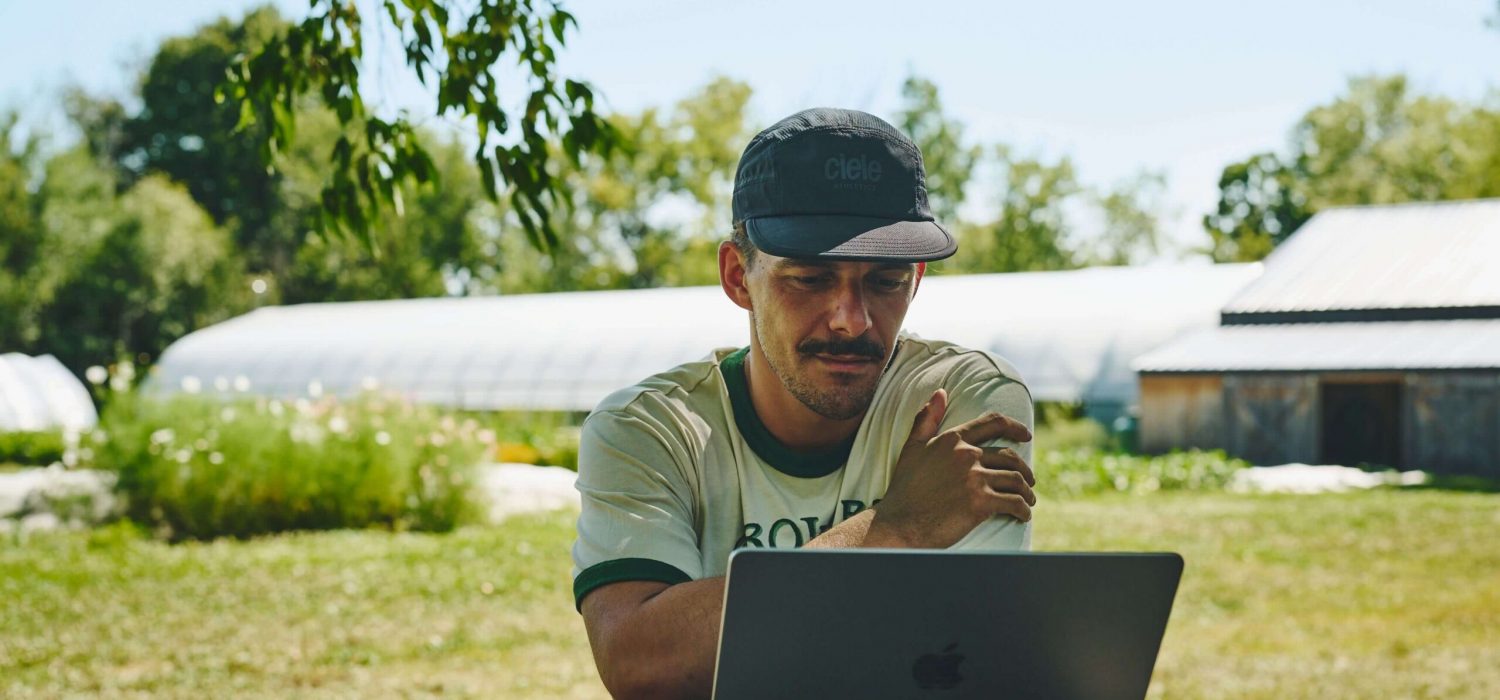 Man sitting in front of his computer outside